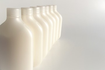 Image of a row of bottle-type plastic containers with space for text