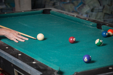 Billiards balls and cue on billiards table. Billiard sport concept