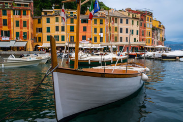Fototapeta na wymiar Classic wooden fish boat closeup. Portofino, is Italian fishing village, Italy. A vacation resort with a picturesque harbour and with celebrity and artistic visitors. Travel and vacation concept.