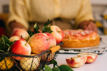 Tasty homemade apple pie on white rustic table. Traditional american dessert. Bio healthy food. Organic apples in basket.
