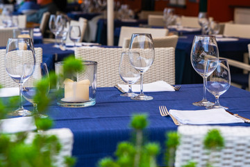Outside exterior outdoors restaurant or trattoria. Restaurant table overlooking the sea on the Liguria coast in Italy.