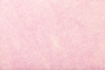 Light pink matt suede fabric closeup. Velvet texture of felt.