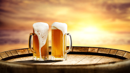 Summer beer on barrel and sunset time. Free space for your bottle 