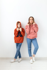 Fototapeta premium Mothers day, children and family concept - teen boy hugging his mom on white background
