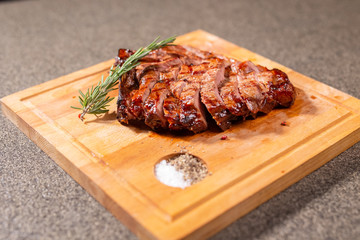 food, delicious and craft concept - cutting horse meat steak on wooden desk