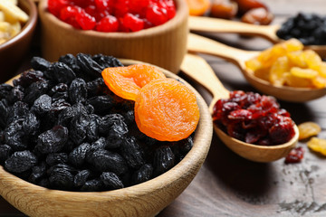 Composition with different dried fruits on wooden background, closeup. Healthy lifestyle