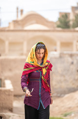 young beautiful iranian lady outside in an old village