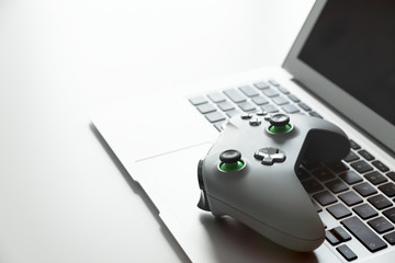 Wireless game pad controller on laptop keyboard © Proxima Studio