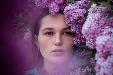  fashion photo of beautiful young woman surrounded by flowers.