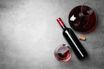 Decanter, glass and bottle with red wine on color background, flat lay. Space for text - obrazy, fototapety, plakaty