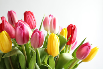 Obraz na płótnie Canvas Beautiful bouquet of bright tulip flowers on white background