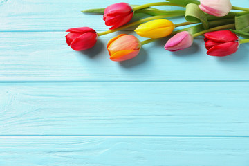 Beautiful tulips and space for text on wooden background, top view. Spring flowers