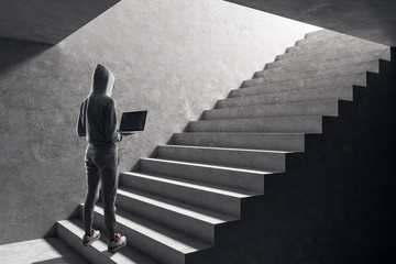 Hacker on concrete stairs