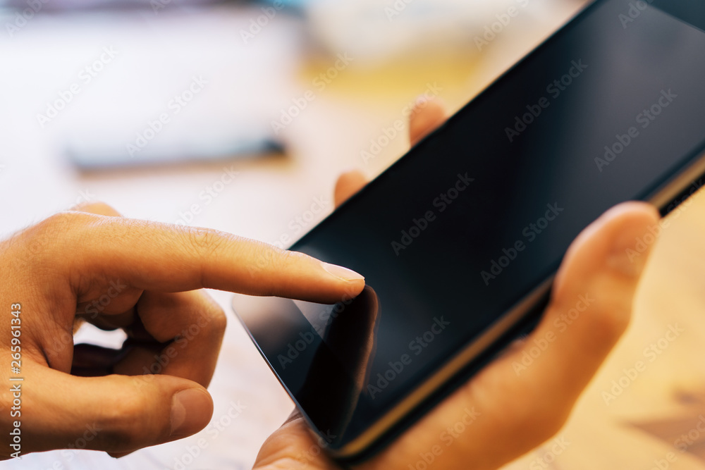 Poster Sideview of man using tablet