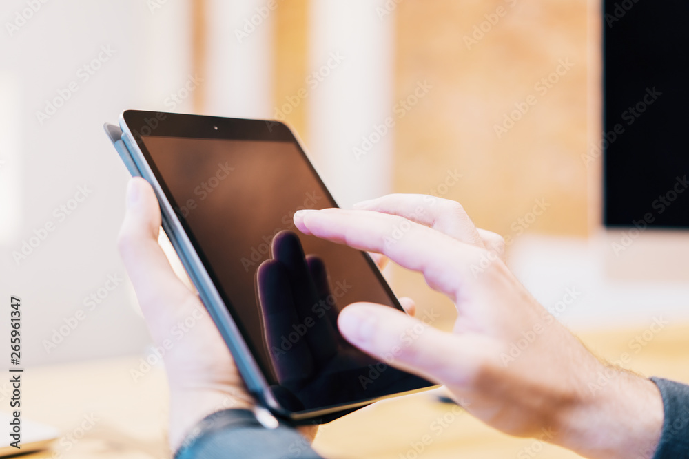 Poster sideview of man using tablet