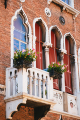 Details of a facade of an old building at the centre street of Venice, Italy, a balcony with...