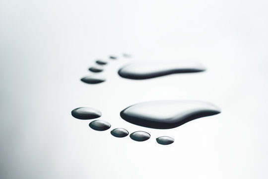 drops on glass in the form of footprints. Macro, close-up.