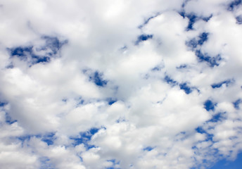 Sky background is vast with white clouds.