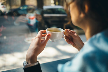 Fototapeta na wymiar Close-up young woman drinking coffee