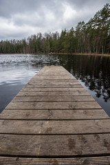 Fototapeta na wymiar wooden plank foothpath boardwalk trampoline in the lake