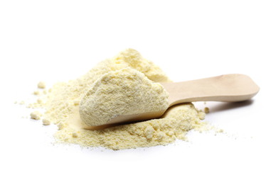 Pile corn flour in wooden spoon isolated on white background