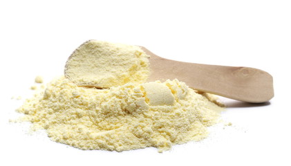 Pile corn flour in wooden spoon isolated on white background