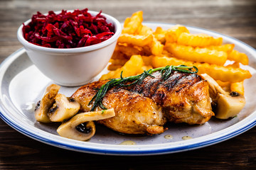 Grilled chicken breast, French fries and vegetables