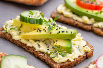 Sandwiches with cream cheese, vegetables and salami.