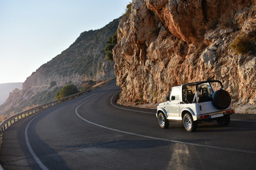 Trip by mountain coast on SUV cabriolet. Travel concept on car