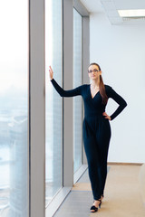 Fototapeta na wymiar beautiful girl business lady in her office in a skyscraper