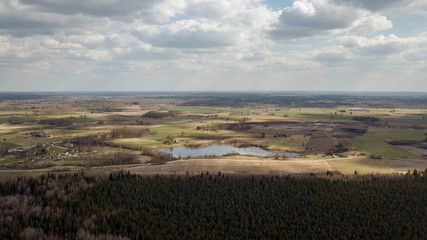 aerial view of countryside fields and forests with small lakes