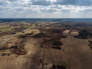 aerial view of countryside fields and forests with small lakes