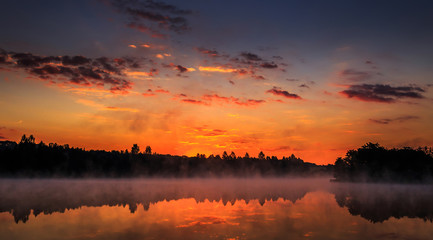 wonderful misty morning. majestic sunrise over the lake. picture
