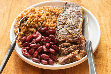 Braised beef steak in red wine with beans & barley