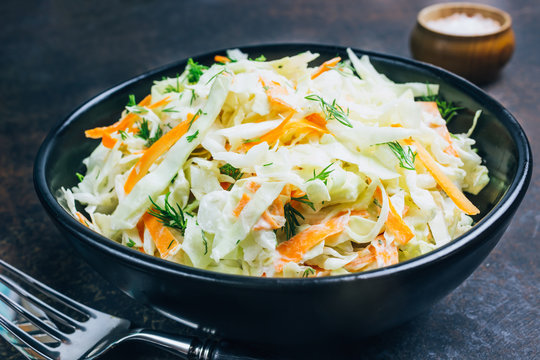 Traditional cole slaw salad in a black bowl