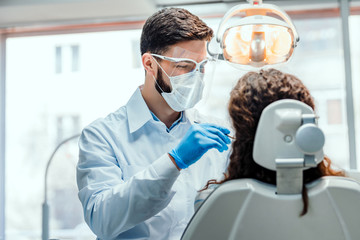 Healthcare and medicine concept.Young dentist working with the female patient in a modern hospital.