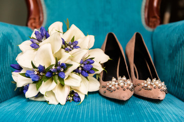 Wedding bouquet next to the bride's shoes