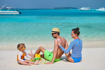 Family with three year old boy on beach