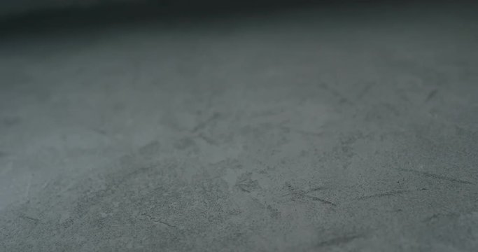 Slow motion shot of decorative dark concrete surface, shot handheld