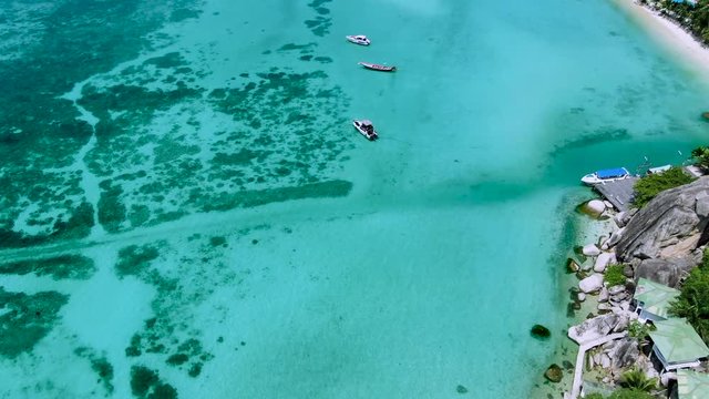 Flight above boats on the ocean at Chalok Baan Kao Bay on the paradisiacal island of Koh tao, Thailand