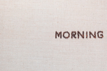 Morning letter sign from coffee beans isolated on linea texture, aligned middle right.