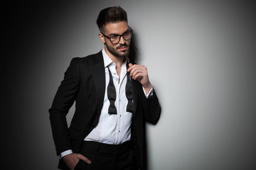 attractive man in tuxedo holding hand in pocket