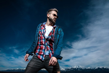  cool fashion man standing against blue sky and mountains