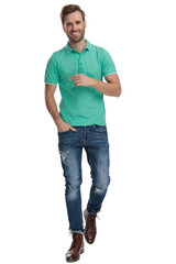 Fototapeta premium cool man walking with hand in pocket