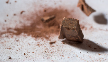 Chocolate on a white background falling dust cacao cocoa