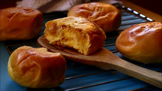 Close up steady video of freshly baked Filipino delicacy called Pan de Coco or bread roll with sweetened coconut filling