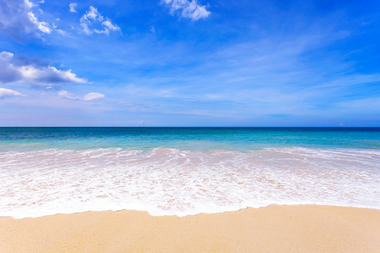 Tropical sandy beach with blue ocean and blue sky background image for nature background or summer background