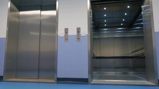 Opening and closing doors of elevator in a large office building. Arriving modern elevator and automatically opening doors of a large office building