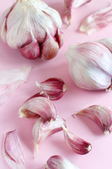 Fresh garlic on a light pink background