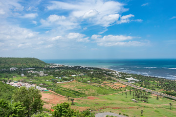 Fototapeta na wymiar top view of sea beach road looking awesome from top of a mountain with blue sky & beautiful sea view.